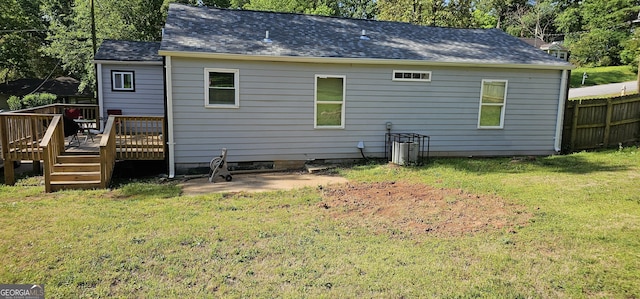 rear view of house with a yard and a deck