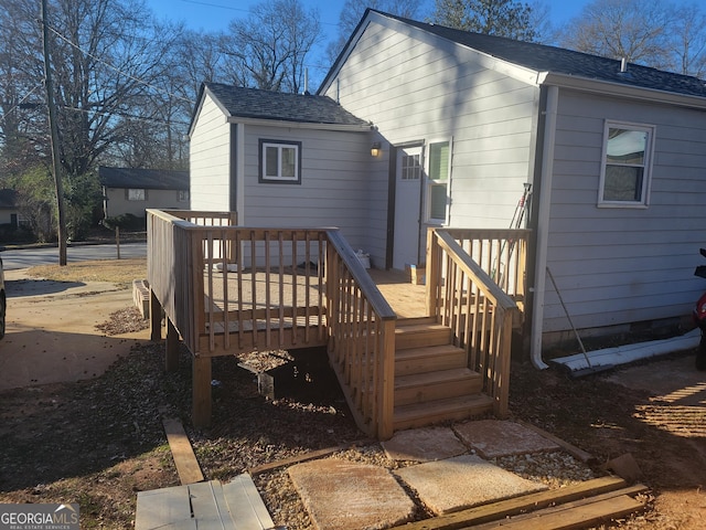 back of property featuring a wooden deck