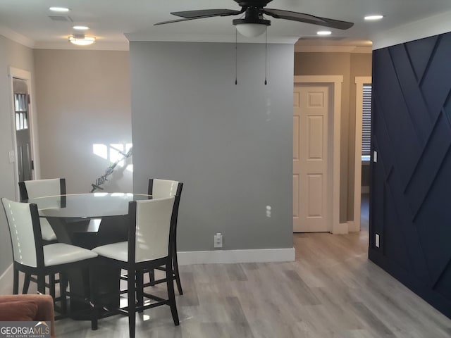 dining area featuring crown molding, ceiling fan, and light hardwood / wood-style flooring