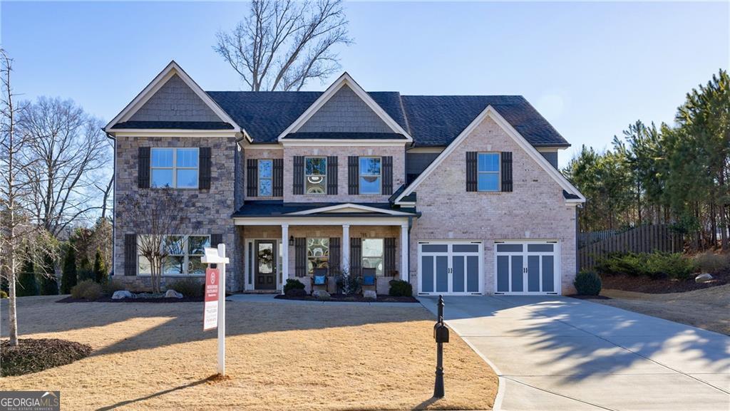 craftsman-style home featuring a garage and covered porch