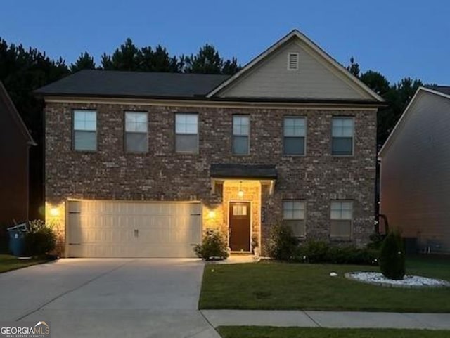 view of front of home featuring a yard and a garage