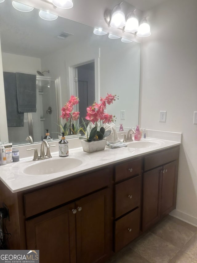 bathroom featuring vanity and an enclosed shower