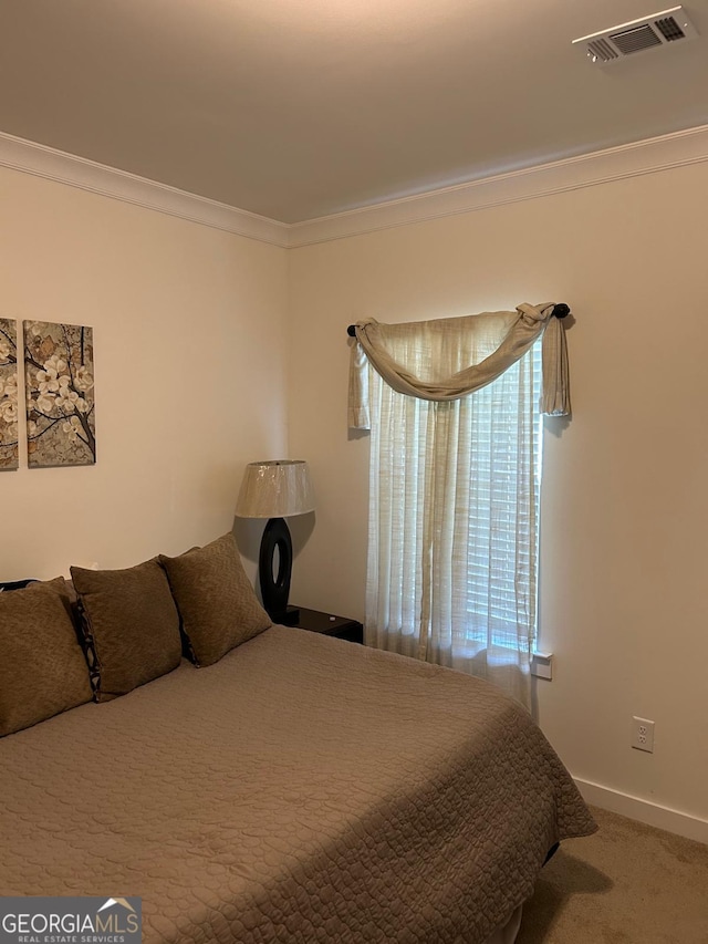 carpeted bedroom featuring ornamental molding