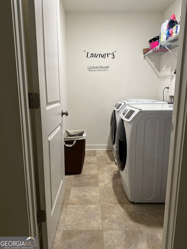 laundry room with washing machine and clothes dryer