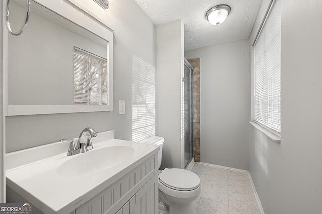 bathroom with toilet, vanity, walk in shower, and a textured ceiling