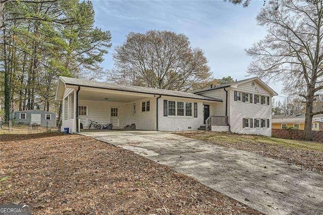 back of house featuring a carport