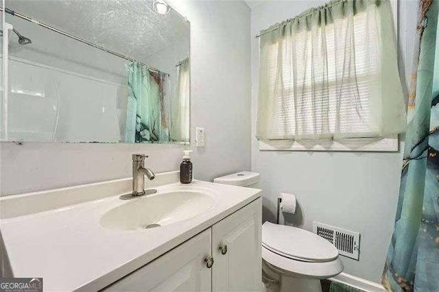 bathroom with vanity and toilet