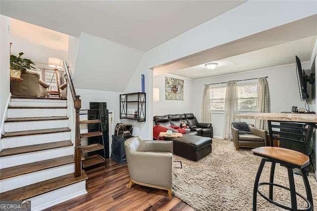 living room featuring dark hardwood / wood-style flooring and vaulted ceiling