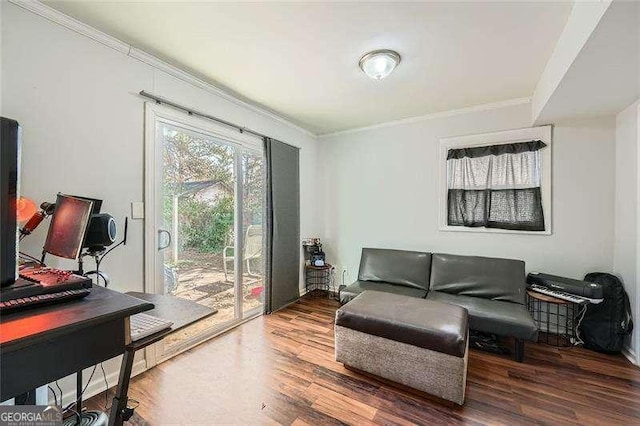 living area with crown molding and hardwood / wood-style floors