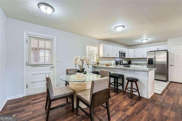 dining space with dark hardwood / wood-style floors