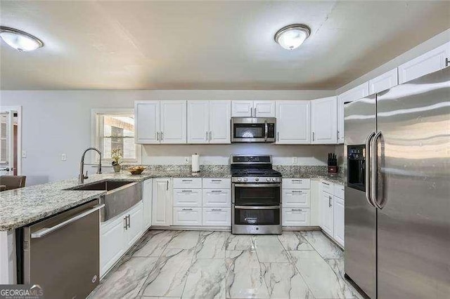 kitchen featuring sink, white cabinets, and appliances with stainless steel finishes