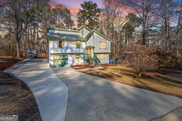 bi-level home featuring a yard and a garage