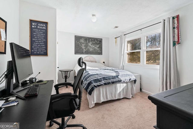 carpeted bedroom featuring a textured ceiling