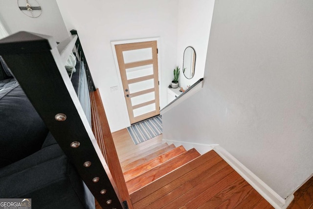 stairs with wood-type flooring