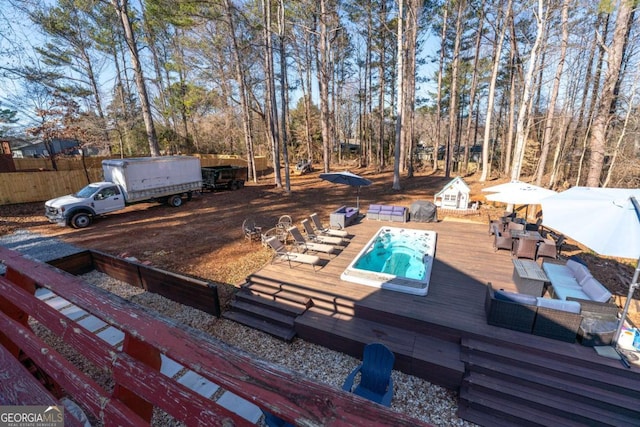 deck with outdoor lounge area and a hot tub