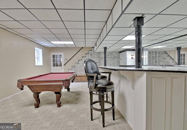 rec room featuring bar, light colored carpet, a drop ceiling, and billiards