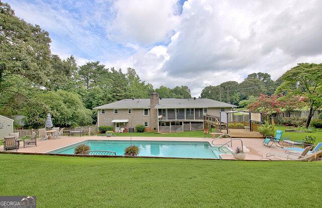 view of swimming pool featuring a yard and a patio