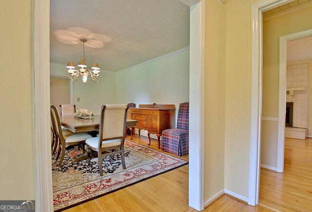 dining room with hardwood / wood-style flooring and a chandelier