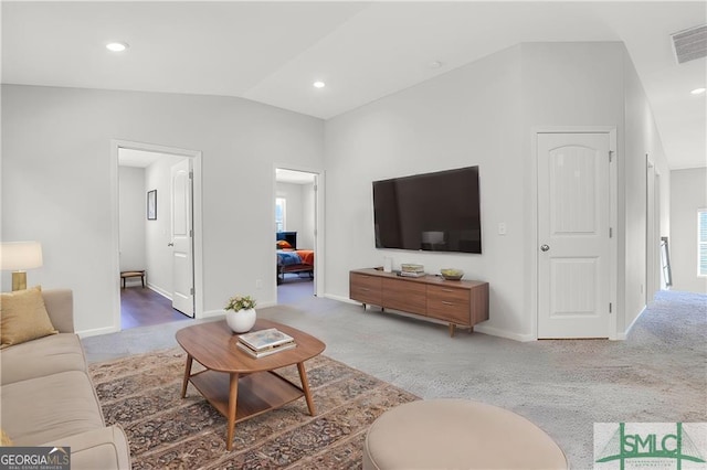 living room with carpet and lofted ceiling