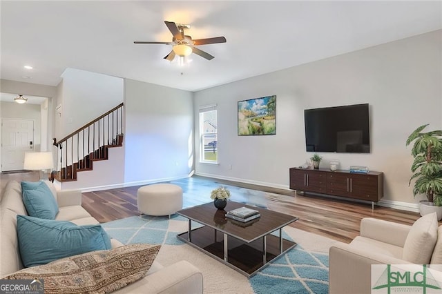 living room with ceiling fan and light hardwood / wood-style floors