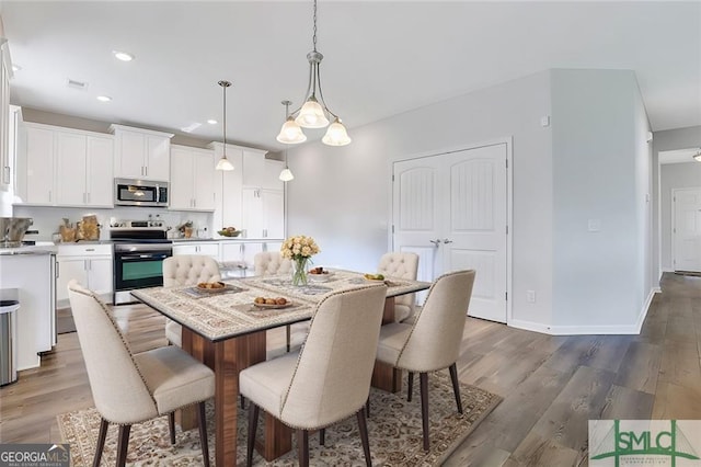 dining area with dark wood-type flooring