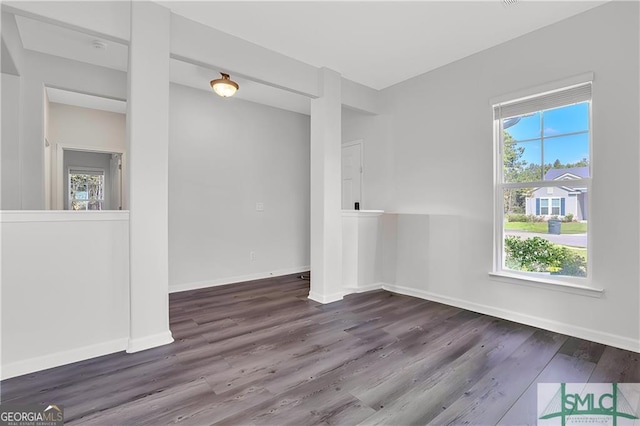 empty room with dark hardwood / wood-style flooring