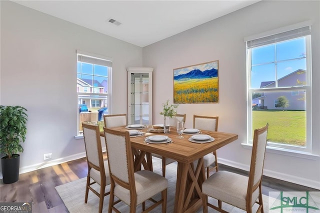 dining space with hardwood / wood-style flooring and a wealth of natural light