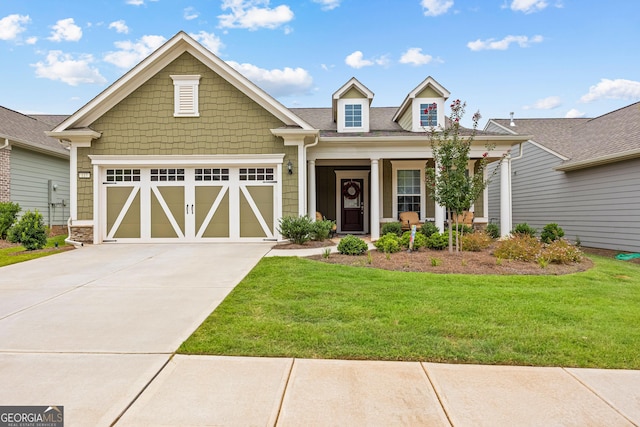 view of front of house with a porch, a front yard, and a garage