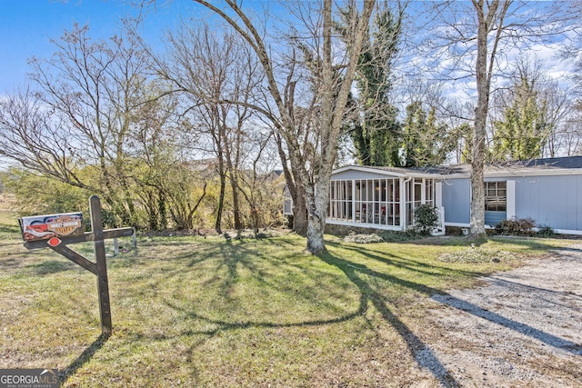 view of yard with a sunroom