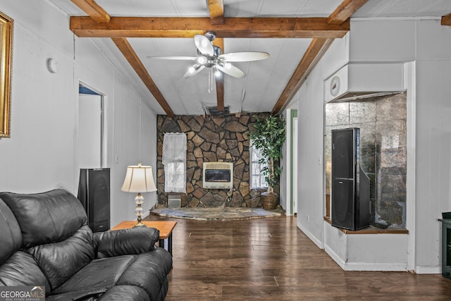 living room with dark wood-type flooring, ceiling fan, a fireplace, beam ceiling, and heating unit