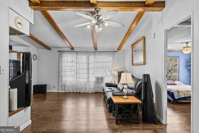 sitting room with beam ceiling, dark hardwood / wood-style flooring, and ceiling fan