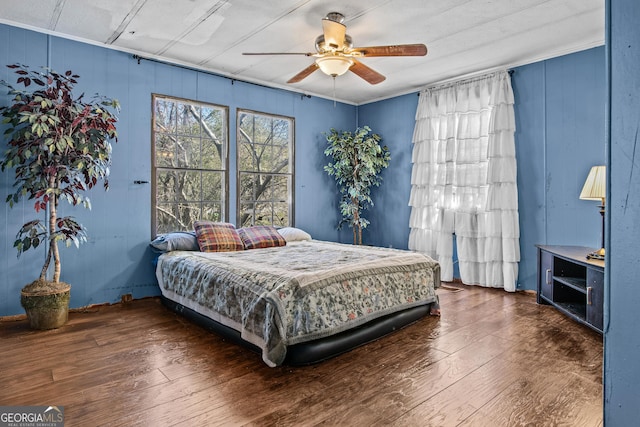 bedroom featuring ceiling fan and dark hardwood / wood-style floors