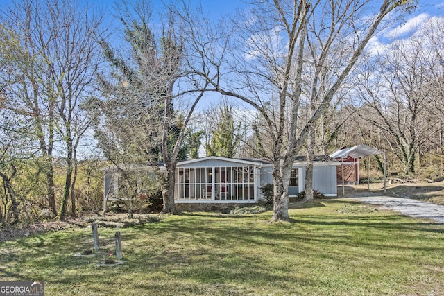 view of yard with a sunroom and a carport