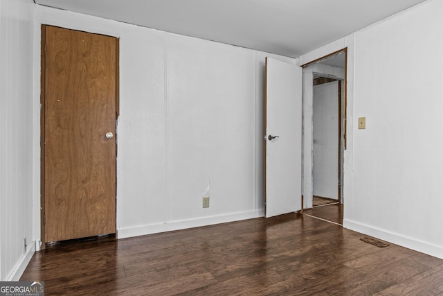 empty room with dark wood-type flooring