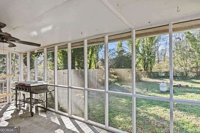 unfurnished sunroom featuring ceiling fan