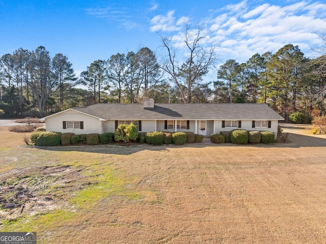 ranch-style house with a front lawn