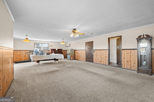 game room with carpet flooring, crown molding, ceiling fan, and a textured ceiling