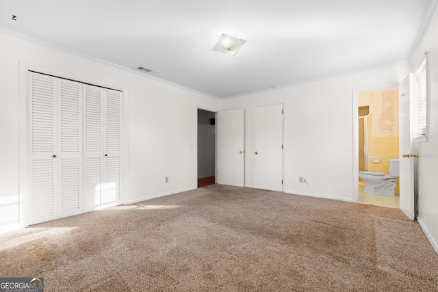 unfurnished bedroom with ensuite bath, carpet floors, and ornamental molding