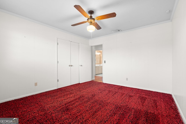 unfurnished bedroom featuring carpet floors, ceiling fan, and crown molding