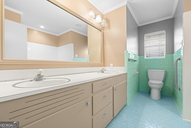 bathroom with vanity, toilet, tile walls, and crown molding