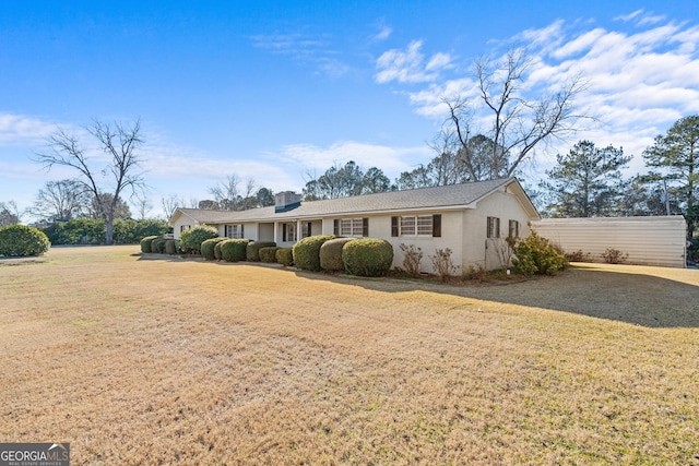 ranch-style home featuring a front yard