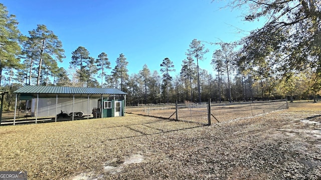 view of yard with an outbuilding and a rural view