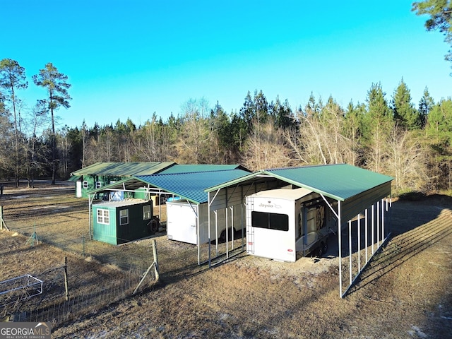 exterior space with an outdoor structure and a carport