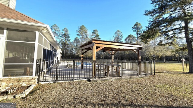 exterior space featuring a swimming pool, a patio area, and a sunroom