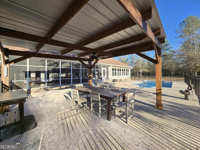 view of patio / terrace with a fenced in pool and ceiling fan