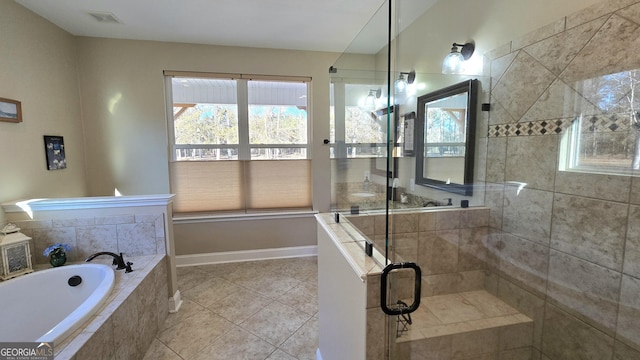 bathroom featuring tile patterned floors, plenty of natural light, and independent shower and bath