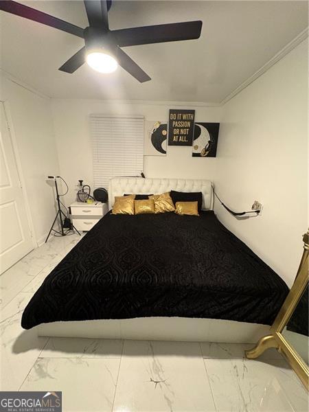 bedroom featuring crown molding and ceiling fan