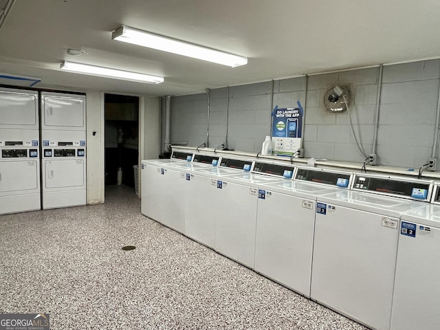 laundry area with stacked washer and clothes dryer and washing machine and clothes dryer