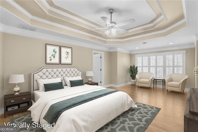 bedroom with a tray ceiling, ceiling fan, and crown molding