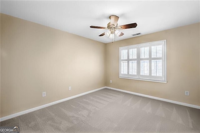 empty room featuring ceiling fan and carpet floors